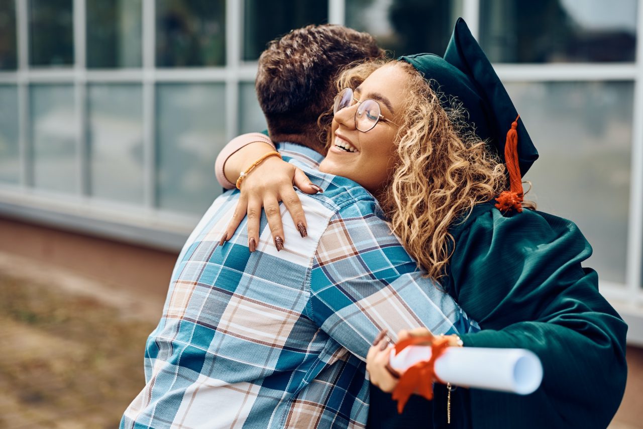 happy student hugging her father after receiving diploma on graduation day at the university .jpg